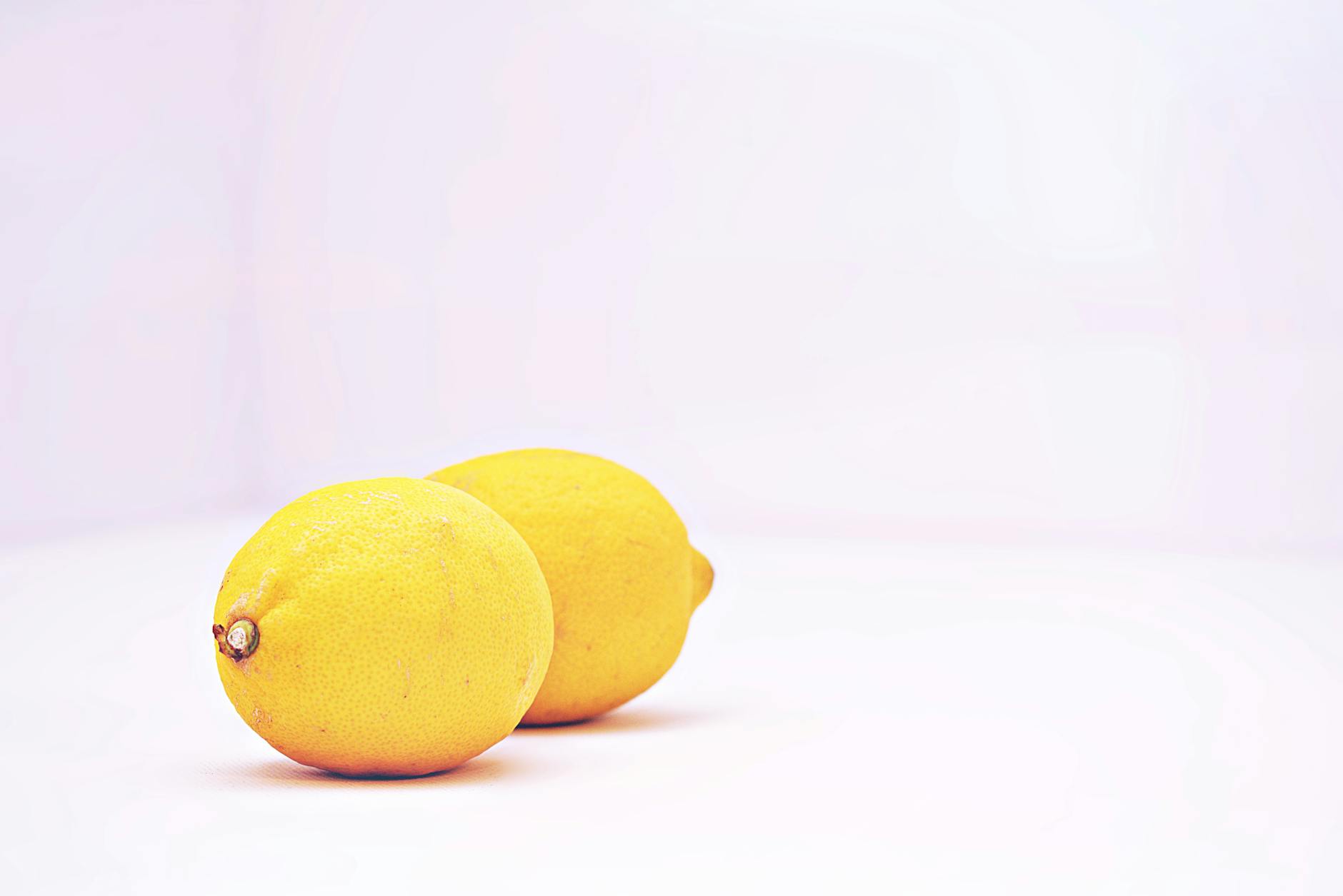 Fresh lemons on a white background, representing freshness and clarity